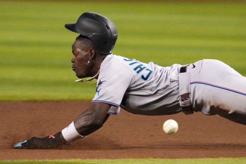 May 9, 2023; Phoenix, Arizona, USA; Miami Marlins center fielder Jazz Chisholm Jr. (2) slides into second base for a steal against the Arizona Diamondbacks during the fifth inning at Chase Field. Mandatory Credit: Joe Camporeale-USA TODAY Sports