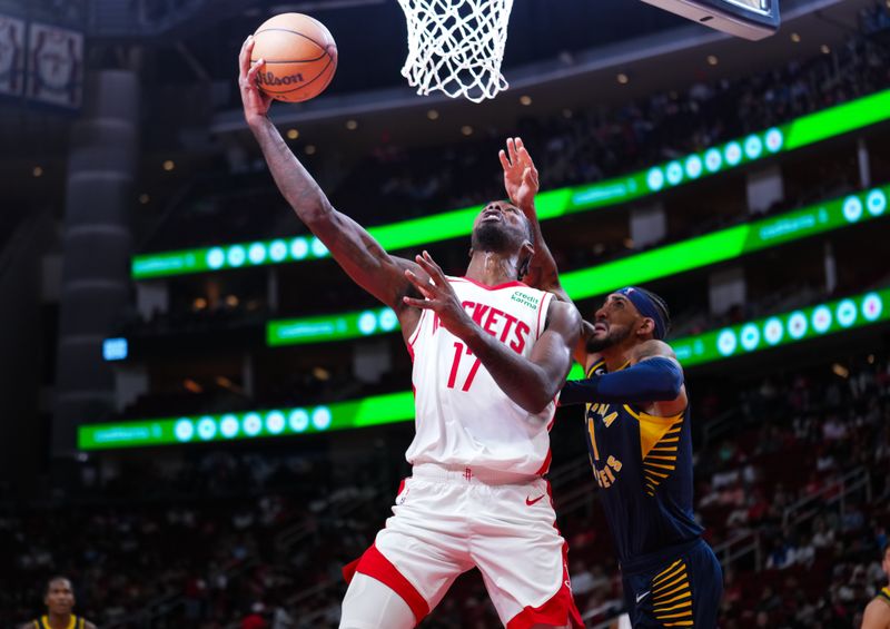 HOUSTON, TEXAS - OCTOBER 10: Tari Eason #17 of the Houston Rockets attempts a layup during the preseason game against the Indiana Pacers at Toyota Center on October 10, 2023 in Houston, Texas. NOTE TO USER: User expressly acknowledges and agrees that, by downloading and or using this photograph, User is consenting to the terms and conditions of the Getty Images License Agreement. (Photo by Alex Bierens de Haan/Getty Images)