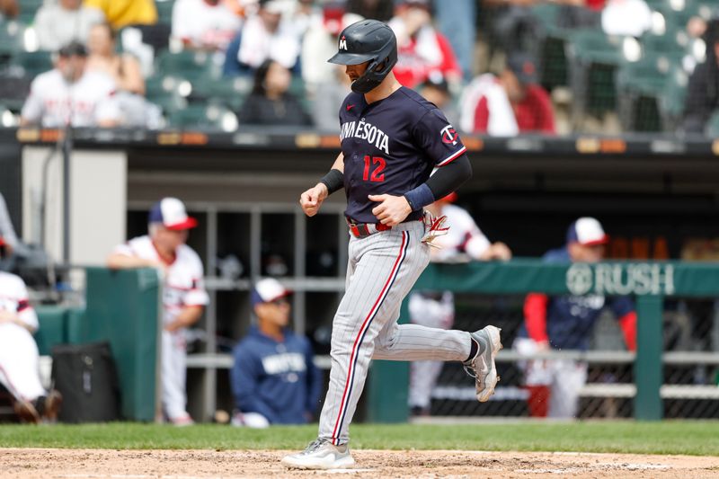 Sep 17, 2023; Chicago, Illinois, USA; Minnesota Twins third baseman Kyle Farmer (12) scores against the Chicago White Sox during the fifth inning at Guaranteed Rate Field. Mandatory Credit: Kamil Krzaczynski-USA TODAY Sports