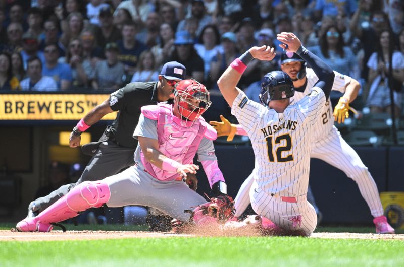 May 12, 2024; Milwaukee, Wisconsin, USA; St. Louis Cardinals catcher Iván Herrera (48) tags out Milwaukee Brewers first base Rhys Hoskins (12) on a base hit in the first inning at American Family Field. Mandatory Credit: Michael McLoone-USA TODAY Sports