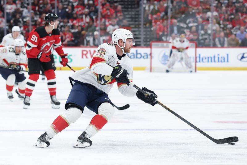 Oct 16, 2025; Newark, New Jersey, USA; Florida Panthers center Sam Bennett (9) skates with the puck against the New Jersey Devils during the first period at Prudential Center. Mandatory Credit: Ed Mulholland-Imagn Images