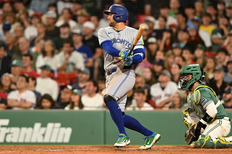 Jun 27, 2025; Boston, Massachusetts, USA; Toronto Blue Jays right fielder George Springer (4) hits a RBI single against the Boston Red Sox during the eighth inning at Fenway Park. Mandatory Credit: Brian Fluharty-Imagn Images