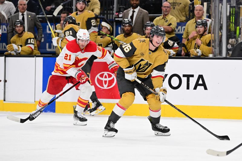 Oct 28, 2024; Las Vegas, Nevada, USA; Calgary Flames center Kevin Rooney (21) chases after Vegas Golden Knights left wing Pavel Dorofeyev (16) in the second period of their game at T-Mobile Arena. Mandatory Credit: Candice Ward-Imagn Images