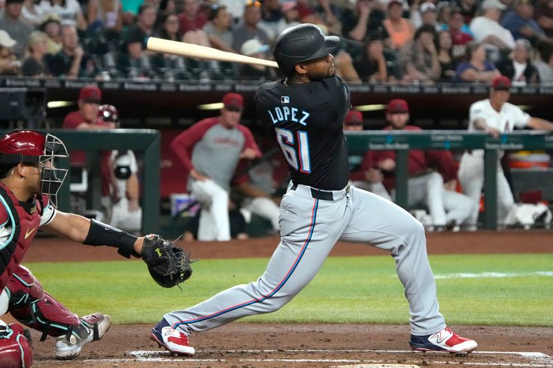 May 24, 2024; Phoenix, Arizona, USA; Miami Marlins third base Otto Lopez (61) hits a two-run single against the Arizona Diamondbacks in the second inning at Chase Field. Mandatory Credit: Rick Scuteri-USA TODAY Sports