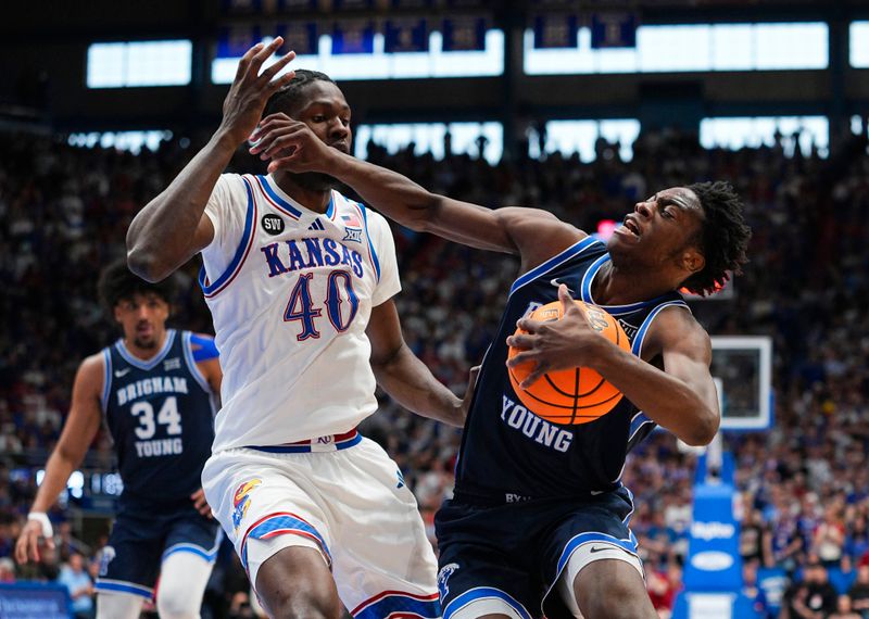 Jan 31, 2026; Lawrence, Kansas, USA; BYU Cougars forward AJ Dybantsa (3) drives against Kansas Jayhawks forward Flory Bidunga (40) during the first half at Allen Fieldhouse. Mandatory Credit: Jay Biggerstaff-Imagn Images