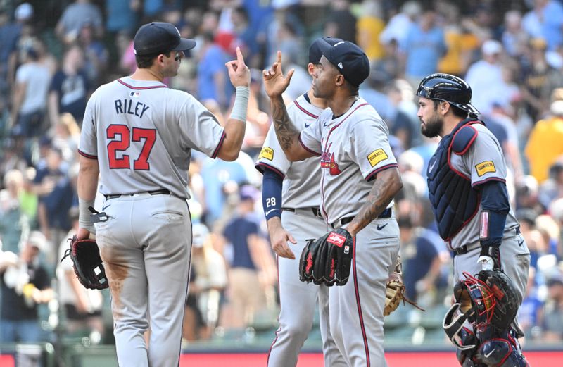 Jul 31, 2024; Milwaukee, Wisconsin, USA; Atlanta Braves third baseman Austin Riley (27) and pitcher Raisel Iglesias (26) celebrate after defeating the Milwaukee Brewers at American Family Field. Mandatory Credit: Michael McLoone-USA TODAY Sports