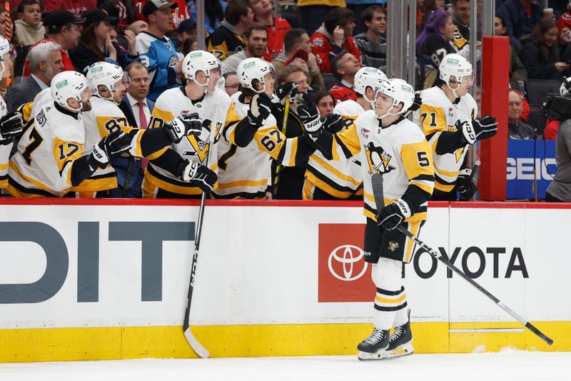 Apr 4, 2024; Washington, District of Columbia, USA; Pittsburgh Penguins defenseman Ryan Shea (5) celebrates with teammates after scoring a goal against the Washington Capitals in the first period at Capital One Arena. Mandatory Credit: Geoff Burke-USA TODAY Sports