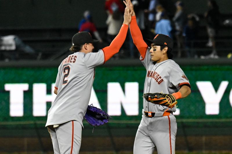 May 6, 2025; Chicago, Illinois, USA;  San Francisco Giants shortstop Willy Adames (2) high fives outfielder Jung Hoo Lee (51) after the game against the Chicago Cubs at Wrigley Field. Mandatory Credit: Matt Marton-Imagn Images