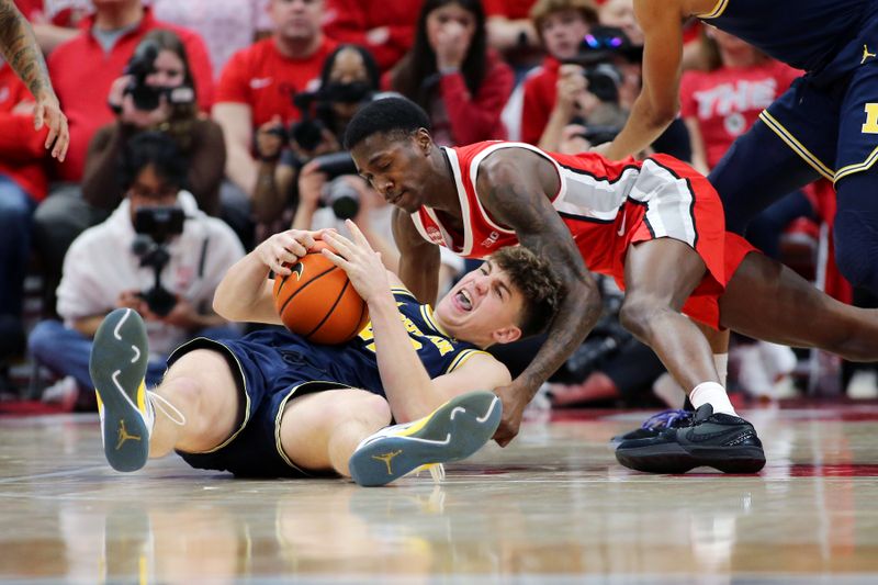 Mar 3, 2024; Columbus, Ohio, USA;  Ohio State Buckeyes guard Scotty Middleton (right) dives for the loose ball as Michigan Wolverines forward Will Tschetter (42) holds onto the ball during the second half at Value City Arena. Mandatory Credit: Joseph Maiorana-USA TODAY Sports