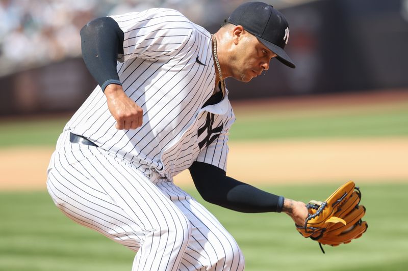 May 3, 2025; Bronx, New York, USA;  New York Yankees relief pitcher Fernando Cruz (63) makes a putout at first base in the sixth inning against the Tampa Bay Rays at Yankee Stadium. Mandatory Credit: Wendell Cruz-Imagn Images