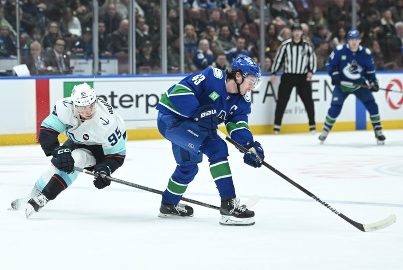 Apr 2, 2025; Vancouver, British Columbia, CAN; Seattle Kraken forward Andre Burakovsky (95) checks Vancouver Canucks defenseman Quinn Hughes (43) during the first period at Rogers Arena. Mandatory Credit: Simon Fearn-Imagn Images