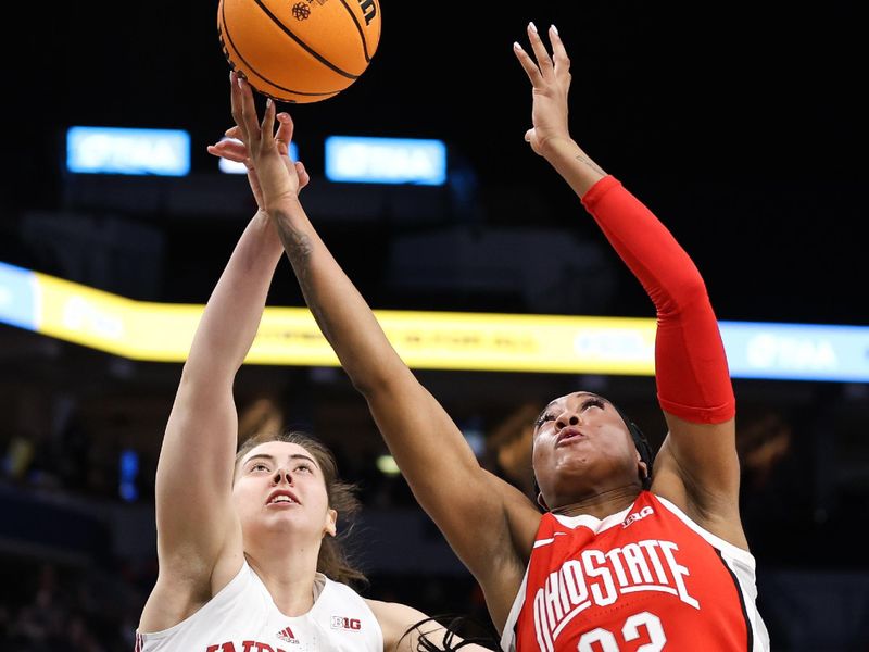 Mar 4, 2023; Minneapolis, MINN, USA; Indiana Hoosiers forward Mackenzie Holmes (54) and Ohio State Buckeyes forward Cotie McMahon (32) jump for the ball during the second half at Target Center. Mandatory Credit: Matt Krohn-USA TODAY Sports