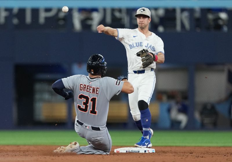 May 18, 2025; Toronto, Ontario, CAN; Detroit Tigers designated hitter Riley Greene (31) is tagged out at second base by Toronto Blue Jays second baseman Ernie Clement (22) during the third inning at Rogers Centre. Mandatory Credit: Nick Turchiaro-Imagn Images