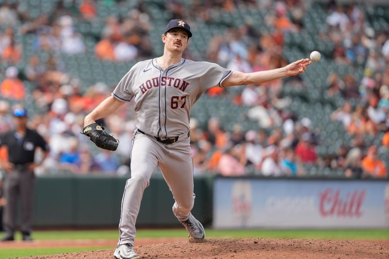 Aug 24, 2025; Baltimore, Maryland, USA; Houston Astros pitcher John Rooney (67) throws over to first base as his first act making his major league debut against the Baltimore Orioles during the sixth inning at Oriole Park at Camden Yards. Mandatory Credit: Gregory Fisher-Imagn Images