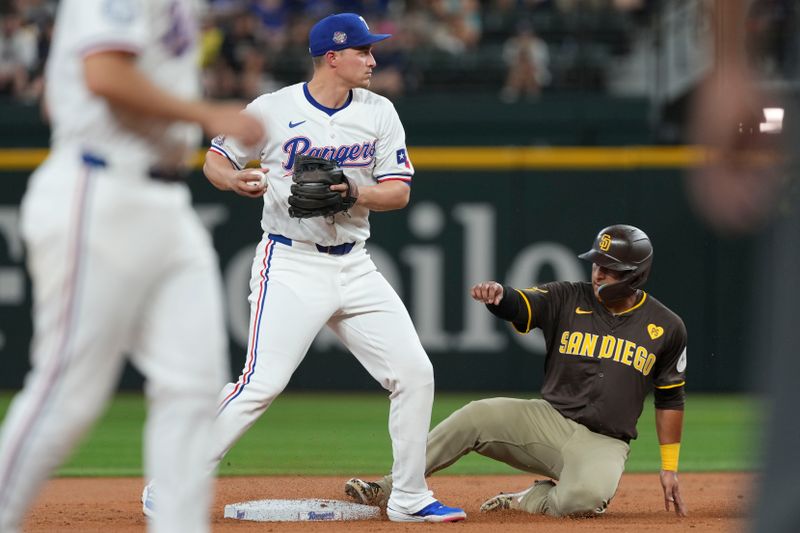 Jul 3, 2024; Arlington, Texas, USA; Texas Rangers shortstop Corey Seager (5) forces out San Diego Padres designated hitter Donovan Solano (39) at second base during the second inning at Globe Life Field. Mandatory Credit: Jim Cowsert-USA TODAY Sports