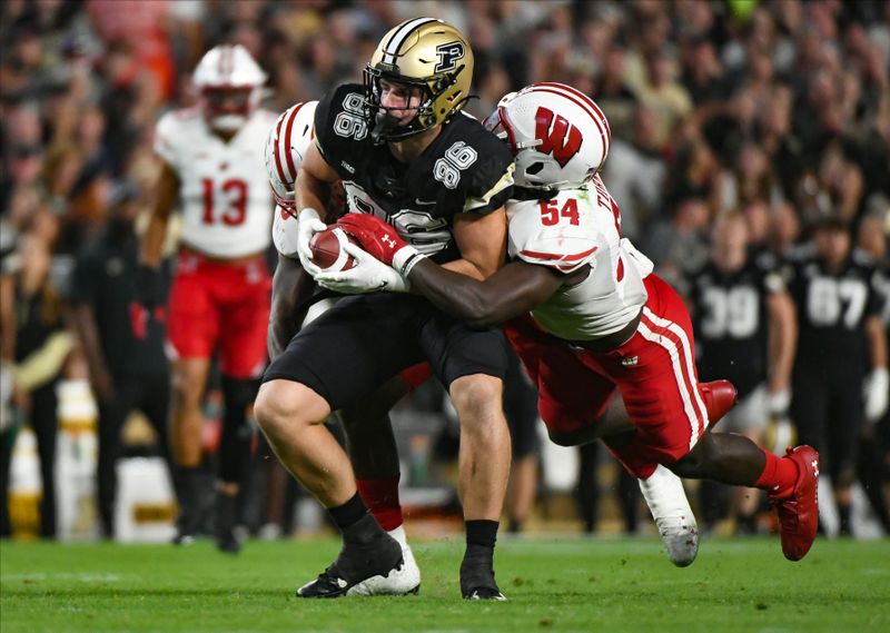 Sep 22, 2023; West Lafayette, Indiana, USA; Wisconsin Badgers inside linebacker Jordan Turner (54) tackles Purdue Boilermakers tight end Max Allen (86) during the second half at Ross-Ade Stadium. Mandatory Credit: Robert Goddin-USA TODAY Sports