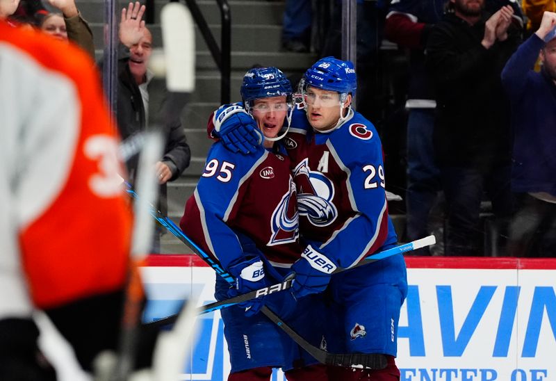 Jan 23, 2026; Denver, Colorado, USA; Colorado Avalanche left wing Victor Olofsson (95) celebrates his goal with center Nathan MacKinnon (29) in the second period against the Philadelphia Flyers at Ball Arena. Mandatory Credit: Ron Chenoy-Imagn Images