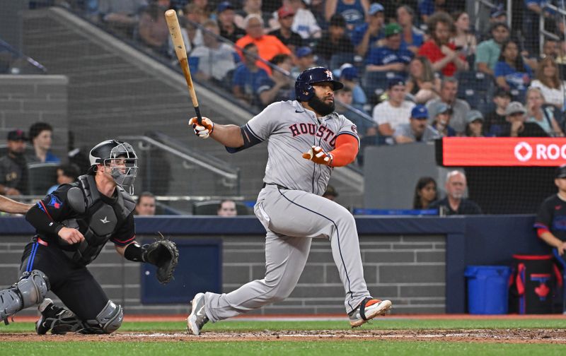 Jul 3, 2024; Toronto, Ontario, CAN; Houston Astros pinch hitter Jon Singleton (28) hits a double in the seventh inning against the Toronto Blue Jays at Rogers Centre. Mandatory Credit: Gerry Angus-USA TODAY Sports