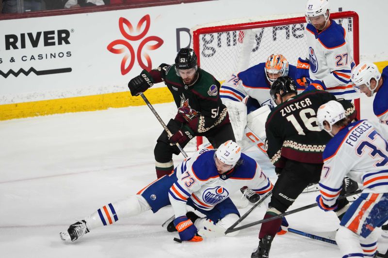 Feb 19, 2024; Tempe, Arizona, USA; Edmonton Oilers defenseman Vincent Desharnais (73) shoves the puck against the Arizona Coyotes during the third period at Mullett Arena. Mandatory Credit: Joe Camporeale-USA TODAY Sports