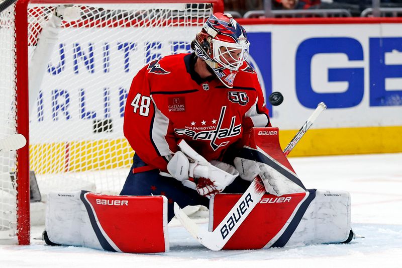 Mar 18, 2025; Washington, District of Columbia, USA; Washington Capitals goaltender Logan Thompson (48) makes a save during the second period against the Detroit Red Wings at Capital One Arena. Mandatory Credit: Peter Casey-Imagn Images