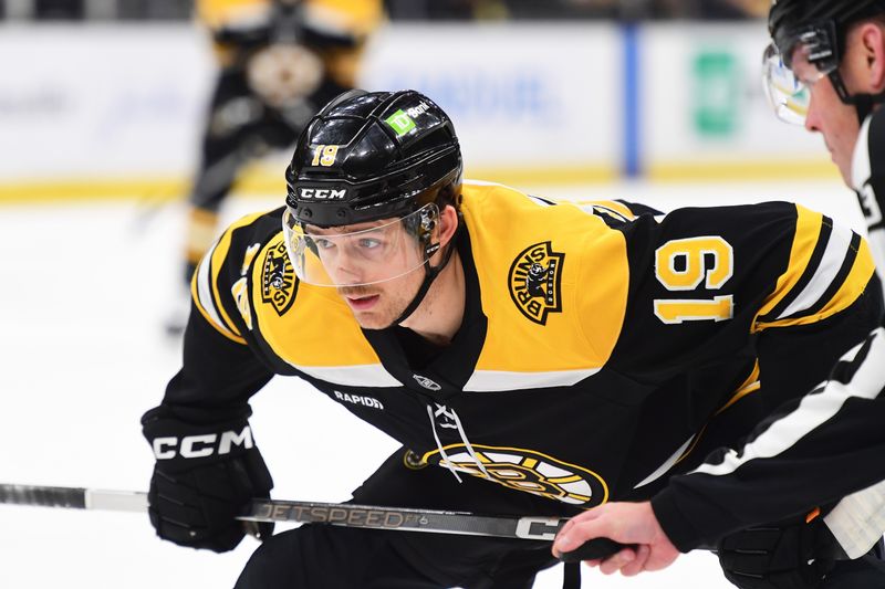 Nov 21, 2024; Boston, Massachusetts, USA;  Boston Bruins center John Beecher (19) gets ready for a face-off during the first period against the Utah Hockey Club at TD Garden. Mandatory Credit: Bob DeChiara-Imagn Images