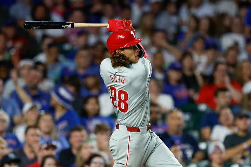 Jul 3, 2024; Chicago, Illinois, USA; Philadelphia Phillies third baseman Alec Bohm (28) hits a two-run home run against the Chicago Cubs during the sixth inning at Wrigley Field. Mandatory Credit: Kamil Krzaczynski-USA TODAY Sports