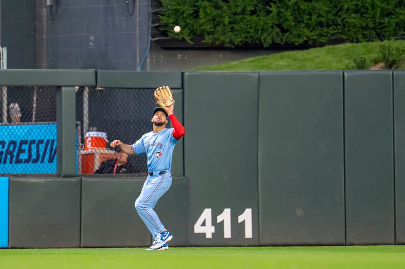 Jun 6, 2025; Minneapolis, Minnesota, USA; Toronto Blue Jays center fielder Jonatan Clase (8) catches a fly ball against the Minnesota Twins in the fourth inning at Target Field. Mandatory Credit: Jesse Johnson-Imagn Images