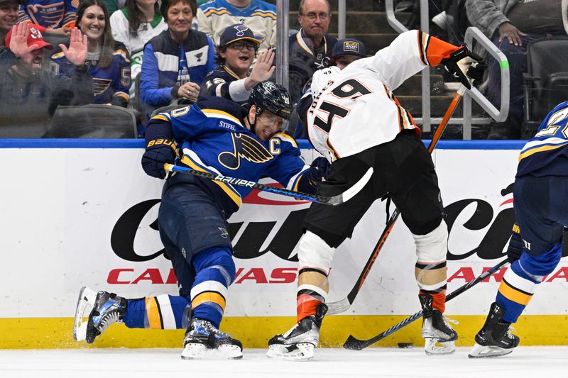 Mar 17, 2024; St. Louis, Missouri, USA; St. Louis Blues center Brayden Schenn (10) checks Anaheim Ducks left wing Max Jones (49) during the third period at Enterprise Center. Mandatory Credit: Jeff Le-USA TODAY Sports