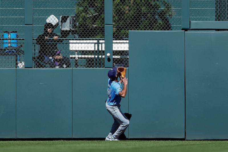 Apr 7, 2024; Denver, Colorado, USA; Tampa Bay Rays outfielder Amed Rosario (10) watches as the ball hits off the fence on a hit in the eighth inning against the Colorado Rockies at Coors Field. Mandatory Credit: Isaiah J. Downing-USA TODAY Sports