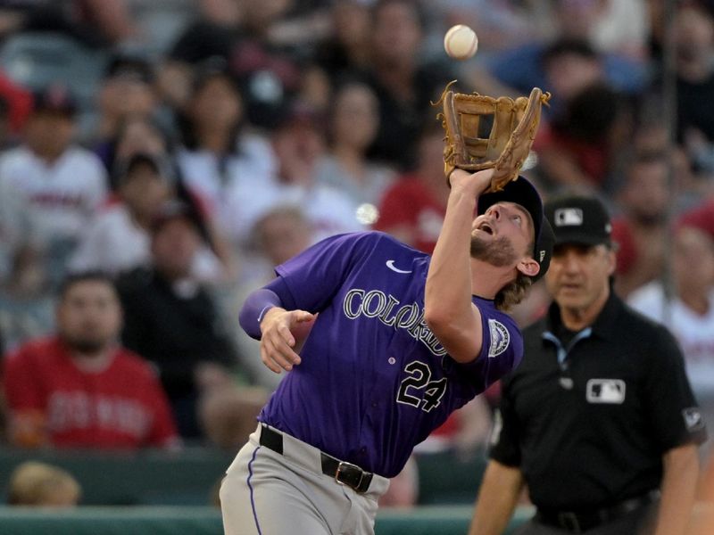 Jul 30, 2024; Anaheim, California, USA;  Los Angeles Angels right fielder Jo Adell (7) flies out to Colorado Rockies third baseman Ryan McMahon (24) in the third inning at Angel Stadium. Mandatory Credit: Jayne Kamin-Oncea-USA TODAY Sports