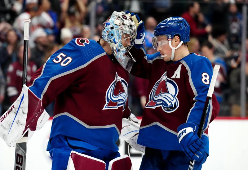 Dec 11, 2023; Denver, Colorado, USA; Colorado Avalanche goaltender Ivan Prosvetov (50) and defenseman Cale Makar (8) celebrate defeating the Calgary Flames at Ball Arena. Mandatory Credit: Ron Chenoy-USA TODAY Sports