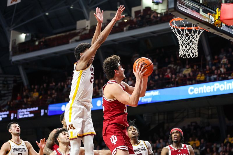 Mar 6, 2024; Minneapolis, Minnesota, USA; Indiana Hoosiers guard Trey Galloway (32) shoots as Indiana Hoosiers forward Payton Sparks (24) defends during the second half at Williams Arena. Mandatory Credit: Matt Krohn-USA TODAY Sports