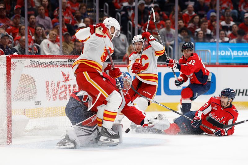 Oct 16, 2023; Washington, District of Columbia, USA; Washington Capitals goaltender Darcy Kuemper (35) makes a save in front off Calgary Flames center Jonathan Huberdeau (10) in the second period at Capital One Arena. Mandatory Credit: Geoff Burke-USA TODAY Sports