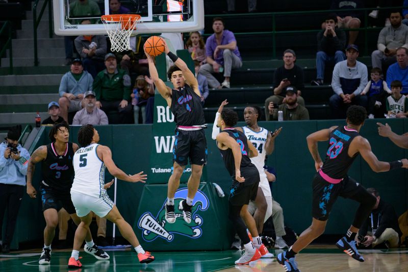 Jan 11, 2024; New Orleans, Louisiana, USA; Florida Atlantic Owls guard Bryan Greenlee (4) grab a rebound against the Tulane Green Wave during the first half at Avron B. Fogelman Arena in Devlin Fieldhouse. Mandatory Credit: Matthew Hinton-USA TODAY Sports