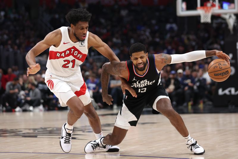 LOS ANGELES, CALIFORNIA - JANUARY 10: Paul George #13 of the LA Clippers dribbles past the defense of Thaddeus Young #21 of the Toronto Raptorsduring the second half of a game at Crypto.com Arena on January 10, 2024 in Los Angeles, California.  NOTE TO USER: User expressly acknowledges and agrees that, by downloading and or using this photograph, User is consenting to the terms and conditions of the Getty Images License Agreement. (Photo by Sean M. Haffey/Getty Images)