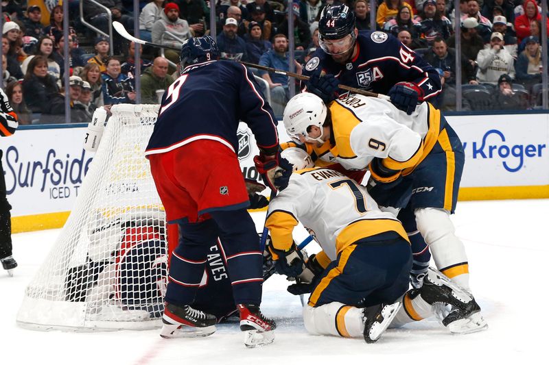 Mar 3, 2026; Columbus, Ohio, USA; Nashville Predators left wing Filip Forsberg (9) sticks the puck under Columbus Blue Jackets goalie Jet Greaves (73) for a goal during the first period at Nationwide Arena. Mandatory Credit: Russell LaBounty-Imagn Images