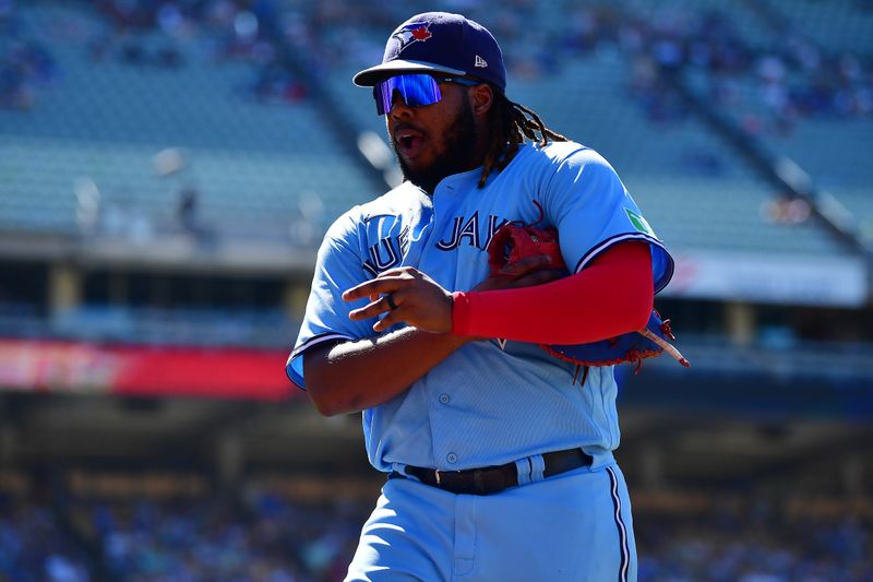 Jul 26, 2023; Los Angeles, California, USA; Toronto Blue Jays first baseman Vladimir Guerrero Jr. (27) returns to the dugout following the bottom of the eighth inning at Dodger Stadium. Mandatory Credit: Gary A. Vasquez-USA TODAY Sports