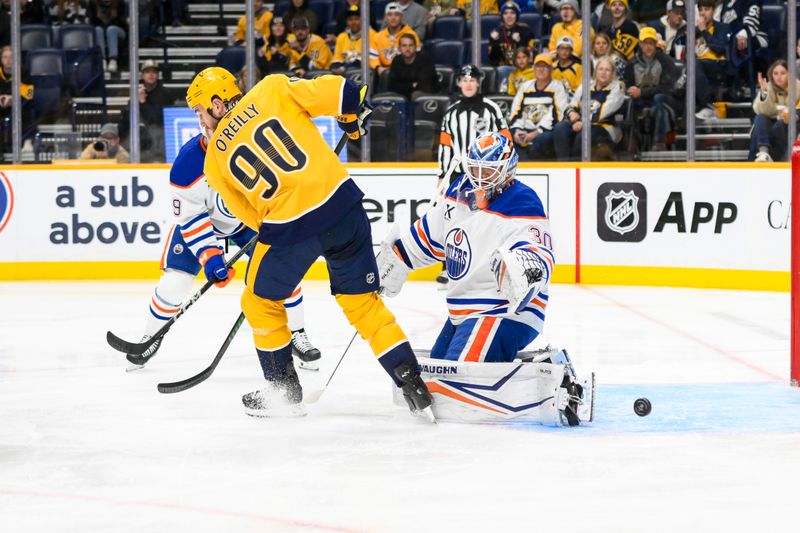 Oct 31, 2024; Nashville, Tennessee, USA; Edmonton Oilers goaltender Calvin Pickard (30) blocks the shot of Nashville Predators center Ryan O'Reilly (90)  during the first period at Bridgestone Arena. Mandatory Credit: Steve Roberts-Imagn Images