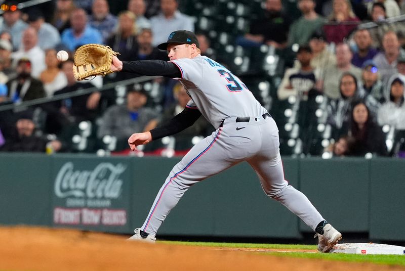 Sep 16, 2025; Denver, Colorado, USA; Miami Marlins first baseman Eric Wagaman (33) fields the ball in the fourth inning against the Colorado Rockies at Coors Field. Mandatory Credit: Ron Chenoy-Imagn Images