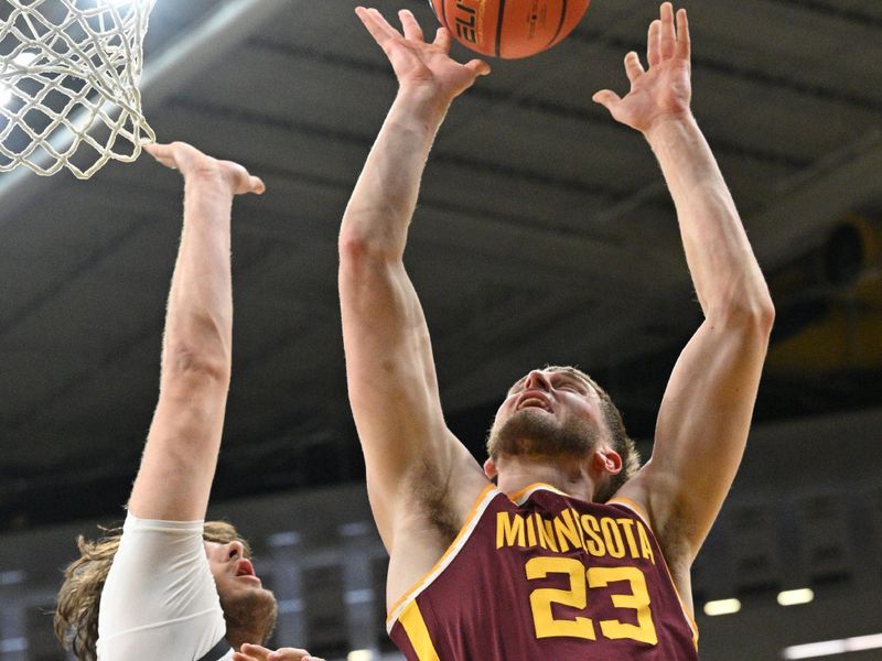 Feb 11, 2024; Iowa City, Iowa, USA; Minnesota Golden Gophers forward Parker Fox (23) goes to the basket as Iowa Hawkeyes forward Owen Freeman (32) defends during the first half at Carver-Hawkeye Arena. Mandatory Credit: Jeffrey Becker-USA TODAY Sports