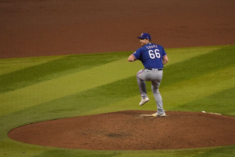 Nov 1, 2023; Phoenix, AZ, USA; Texas Rangers relief pitcher Josh Sborz (66) pitches in the eighth inning against the Arizona Diamondbacks in game five of the 2023 World Series at Chase Field. Mandatory Credit: Joe Camporeale-USA TODAY Sports