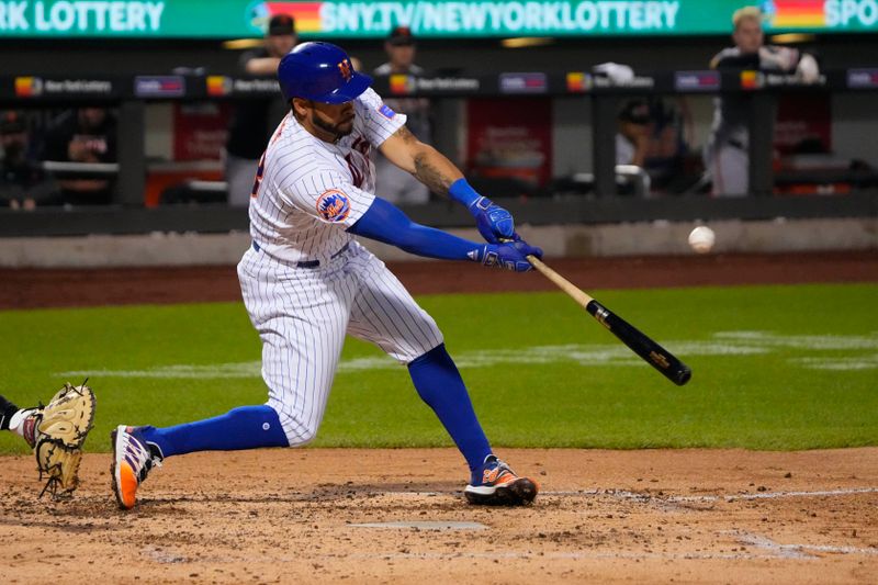 Jul 2, 2023; New York City, New York, USA; New York Mets left fielder Tommy Pham (28) hits an RBI double against the San Francisco Giants during the fourth inning at Citi Field. Mandatory Credit: Gregory Fisher-USA TODAY Sports