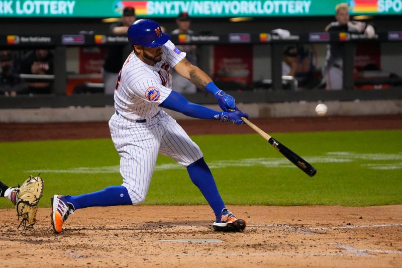 Jul 2, 2023; New York City, New York, USA; New York Mets left fielder Tommy Pham (28) hits an RBI double against the San Francisco Giants during the fourth inning at Citi Field. Mandatory Credit: Gregory Fisher-USA TODAY Sports