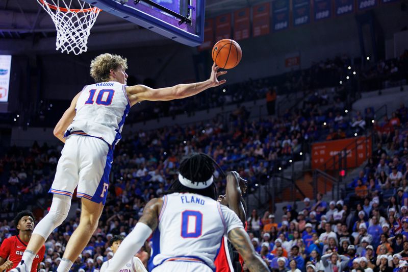 Jan 6, 2026; Gainesville, Florida, USA; Florida Gators forward Thomas Haugh (10) blocks a shot from a Georgia Bulldogs player during the first half at Exactech Arena at the Stephen C. O'Connell Center. Mandatory Credit: Morgan Tencza-Imagn Images