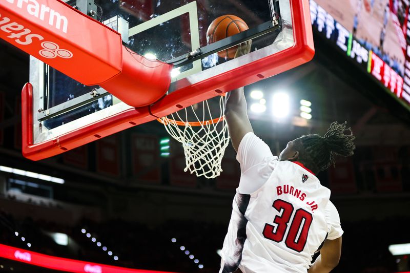 Feb 19, 2023; Raleigh, North Carolina, USA; North Carolina State Wolfpack forward D.J. Burns Jr. (30) dunks during the first half of the game against North Carolina Tar Heels at PNC Arena. Mandatory Credit: Jaylynn Nash-USA TODAY Sports