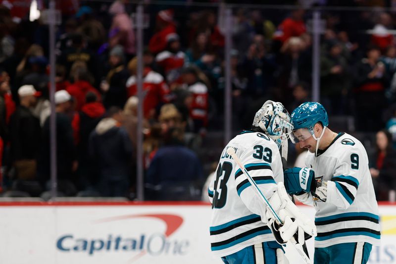Jan 15, 2026; Washington, District of Columbia, USA; San Jose Sharks goaltender Alex Nedeljkovic (33) celebrates with Sharks defenseman Dmitry Orlov (9) after their game against the Washington Capitals at Capital One Arena. Mandatory Credit: Geoff Burke-Imagn Images