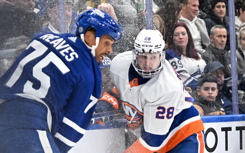 Feb 5, 2024; Toronto, Ontario, CAN;   New York Islanders defenseman Alexander Romanov (28) and Toronto Maple Leafs forward Ryan Reaves (75) spray ice chips as they battle on the boards in the first period at Scotiabank Arena. Mandatory Credit: Dan Hamilton-USA TODAY Sports