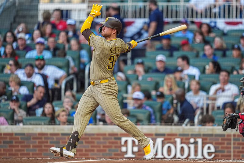 May 23, 2025; Cumberland, Georgia, USA; San Diego Padres designated hitter Gavin Sheets (30) hits a home run against the Atlanta Braves during the second inning at Truist Park. Mandatory Credit: Dale Zanine-Imagn Images