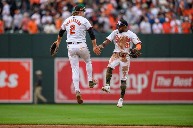 May 19, 2024; Baltimore, Maryland, USA; Baltimore Orioles shortstop Gunnar Henderson (2) and outfielder Cedric Mullins (31) celebrate after the game against the Seattle Mariners at Oriole Park at Camden Yards. Mandatory Credit: Reggie Hildred-USA TODAY Sports
