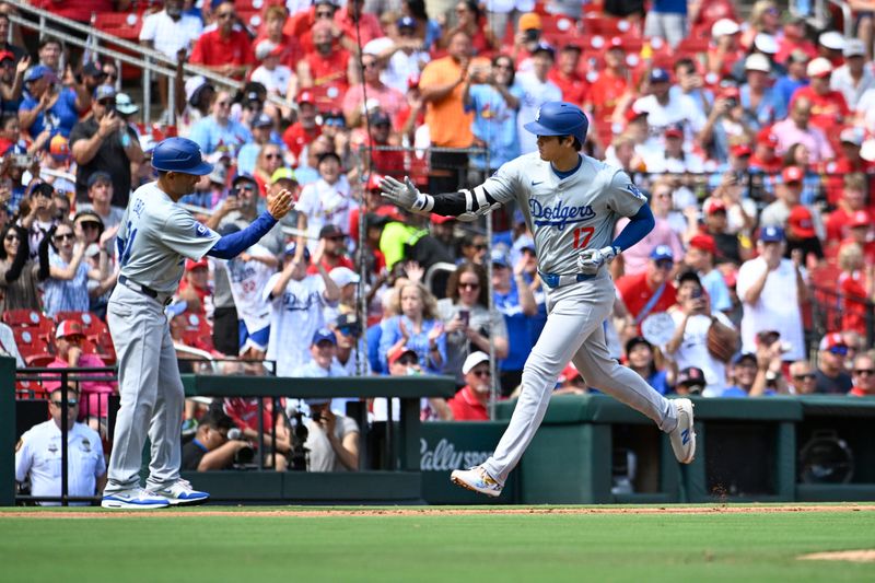 Aug 18, 2024; St. Louis, Missouri, USA; Los Angeles Dodgers designated hitter Shohei Ohtani (17) is congratulated by Los Angeles Dodgers third base coach Dino Ebel (91) after hitting a solo home run against the St. Louis Cardinals in the fifth inning at Busch Stadium. Mandatory Credit: Joe Puetz-USA TODAY Sports